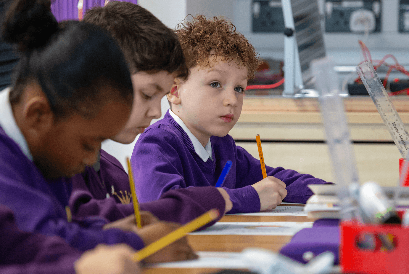 Student paying attention holding a pencil