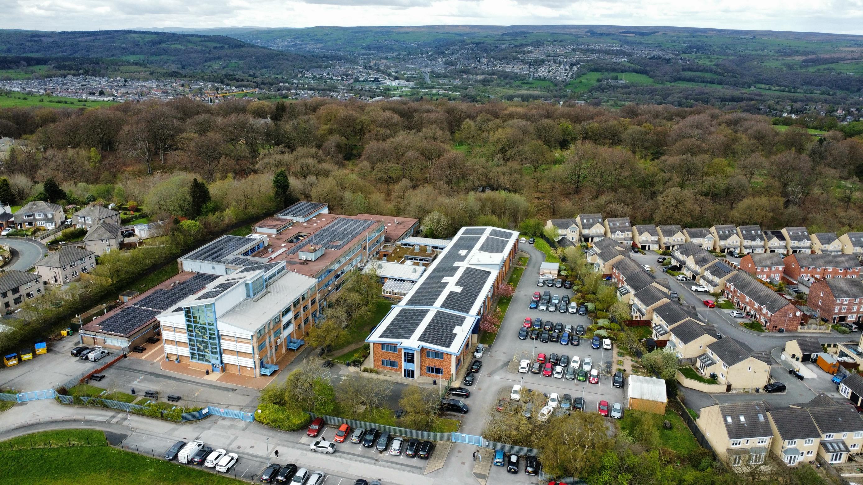 View of a school building with solar panels on it, from the air