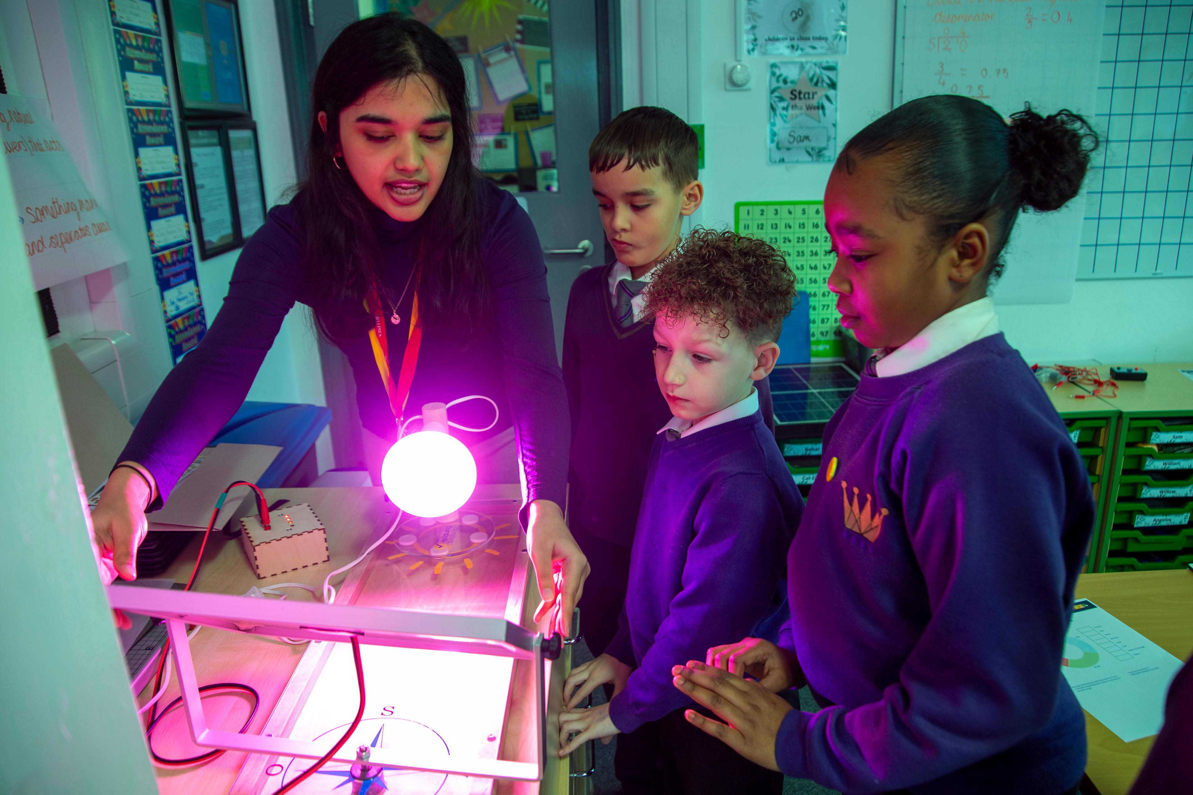 Sanchi Singh, one of Solar for Schools Education Team, helps students use the Solar Explorer Ki